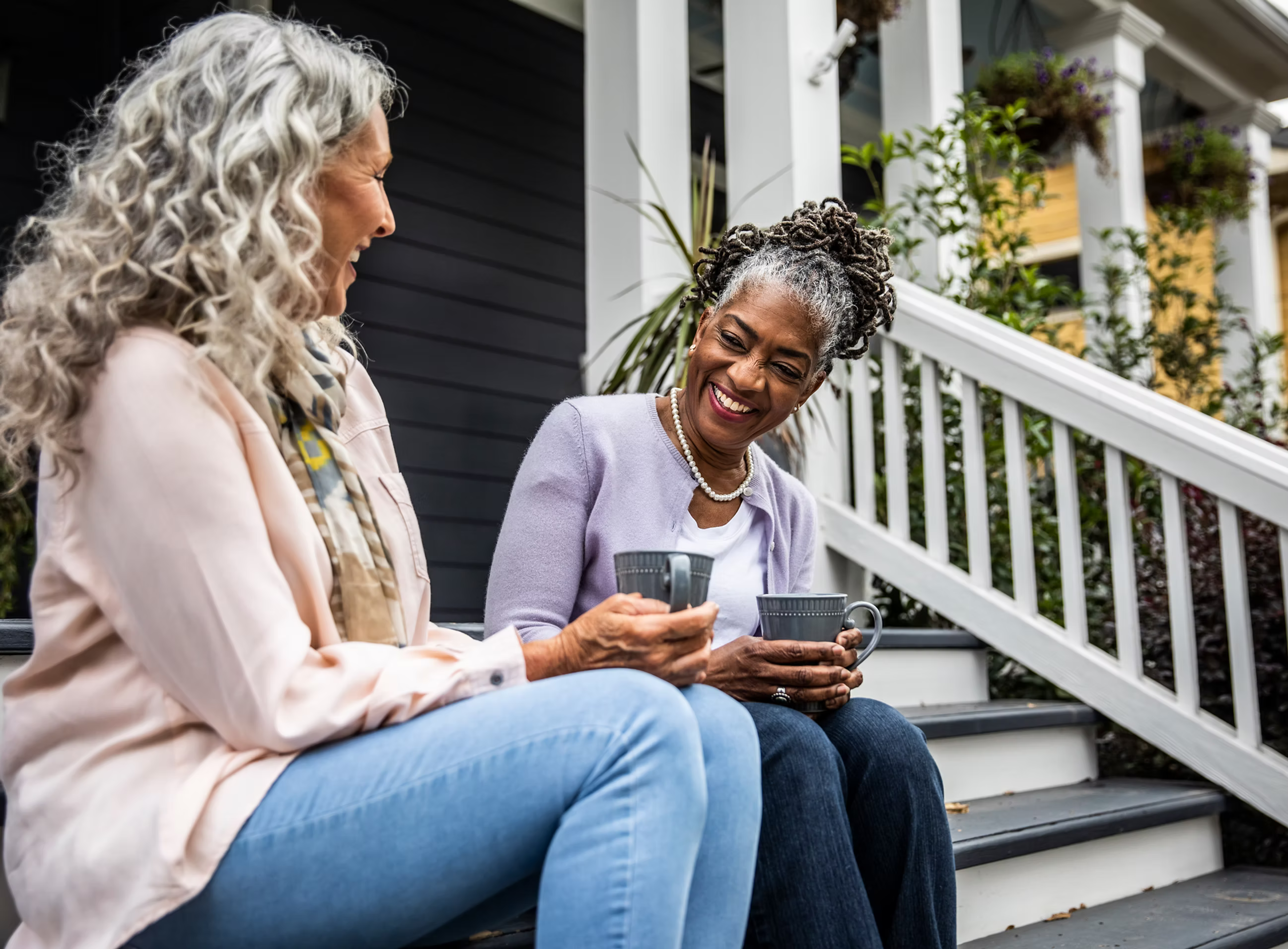 Two women having a friendly conversation on porch